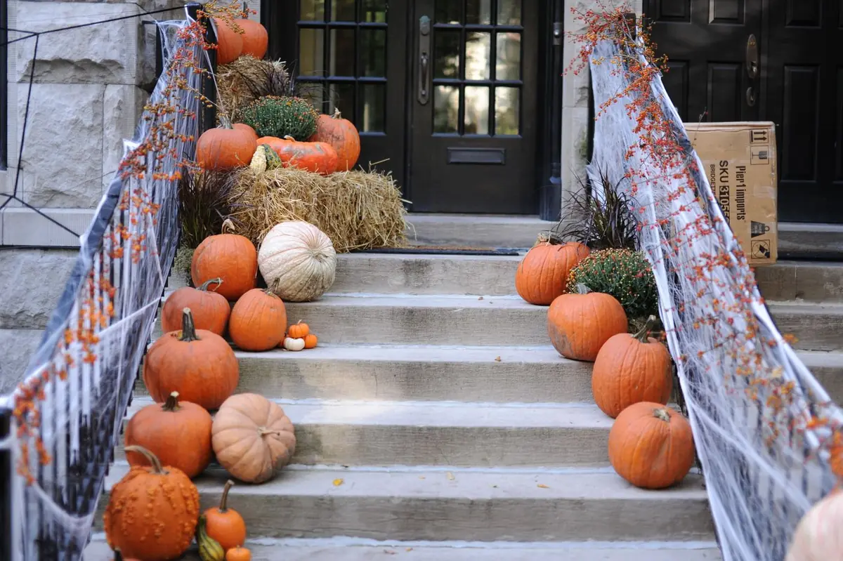 Stone staircase lined with orange and white pumpkins